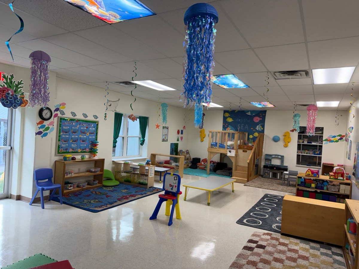 Classroom decorated with hanging jellyfish and colorful rugs