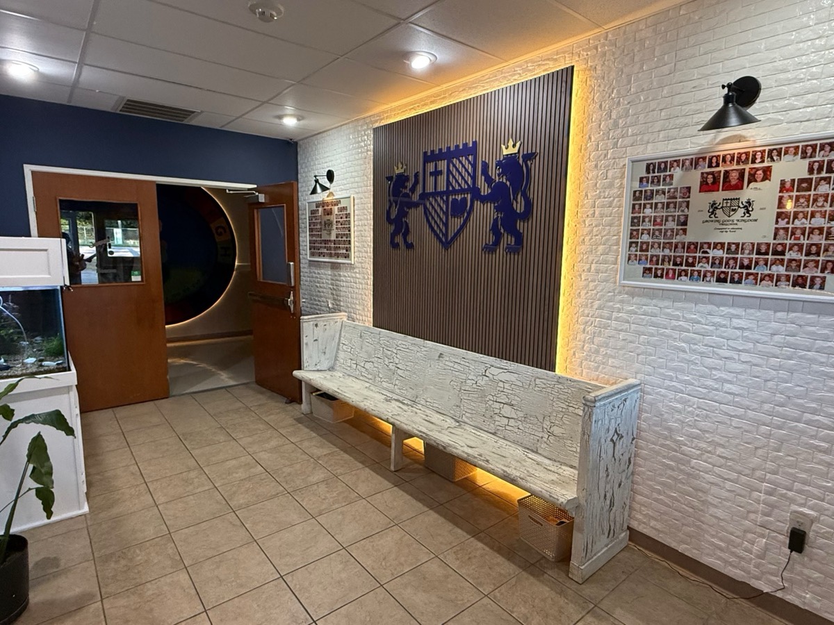 GGK's welcoming lobby with a wooden pallet wall and lit cut-out logo