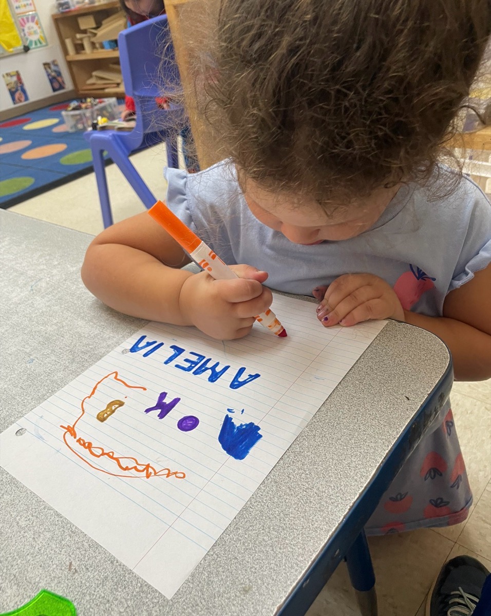 A child writing her name